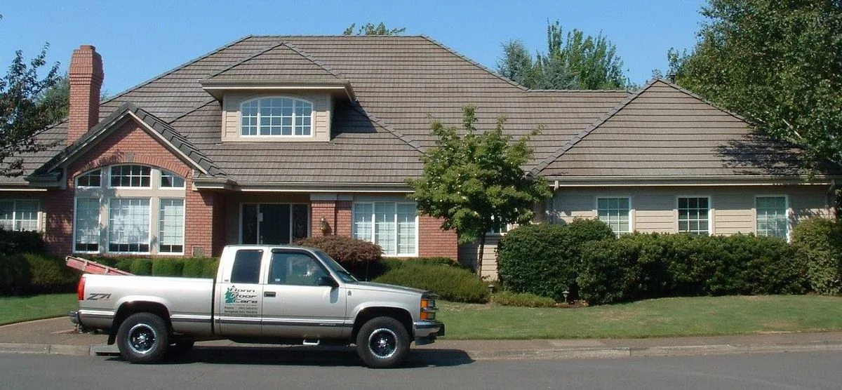 Bonn Roof Care truck parked at a Lane County home during a roof service visit